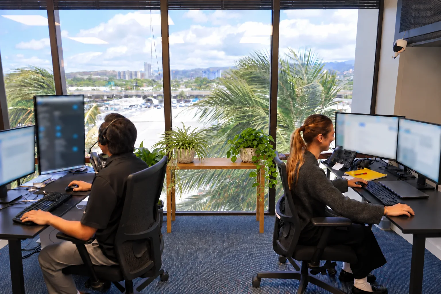Two members of the Enlighten team working in the Honolulu office.